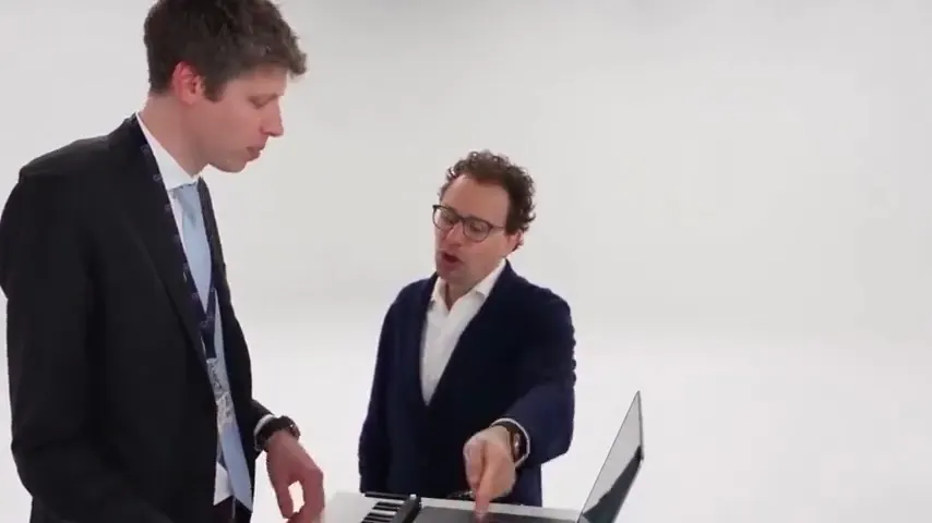 An Alors on Danse AI trend video: two men in suits at a laptop and mini keyboard in a white studio, one steals the camera, then both dance away